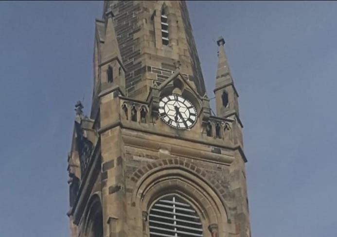 The church clock seated below the spire.